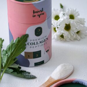 Elegant still life photo of collagen peptides product with green leaves and white flowers.