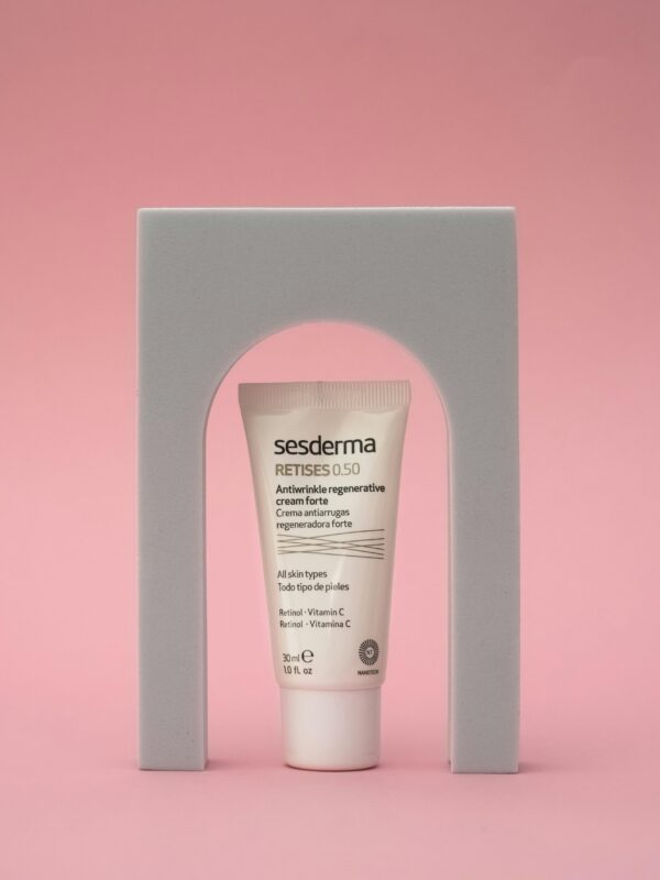 Luxury cosmetic cream displayed elegantly against a pink background with modern aesthetics.