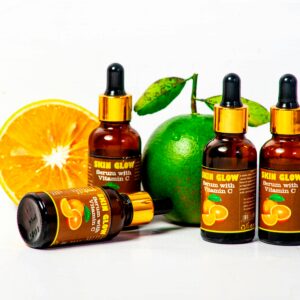 Vitamin C serum bottles with fresh citrus fruits for skincare and health promotion.